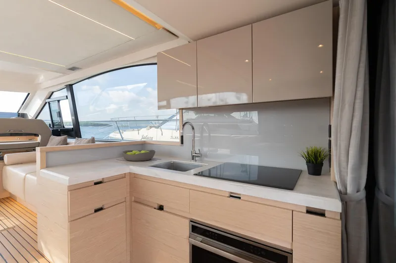  Yacht Photos Pics Modern kitchen interior on 2022 Monte Carlo 52 yacht with sleek design and ocean view.