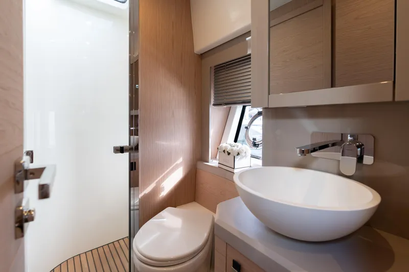  Yacht Photos Pics Luxurious bathroom interior of 2022 Monte Carlo 52 yacht with modern fixtures.