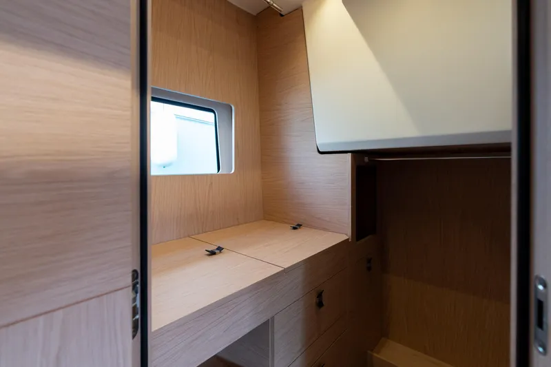  Yacht Photos Pics Interior of 2022 Monte Carlo 52 yacht with wooden cabinetry and window.