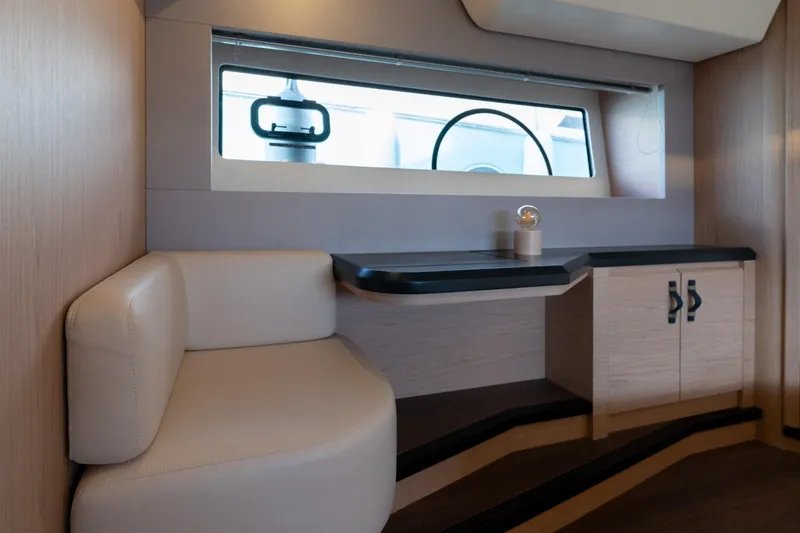  Yacht Photos Pics Interior of 2022 Monte Carlo 52 yacht with modern seating and window view.
