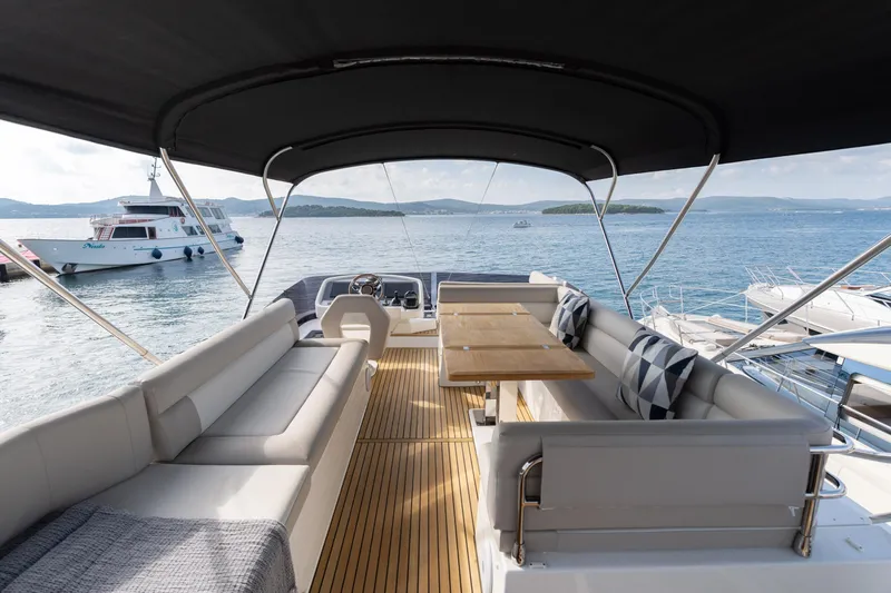  Yacht Photos Pics Luxurious 2022 Monte Carlo 52 yacht interior with elegant seating and scenic ocean view.