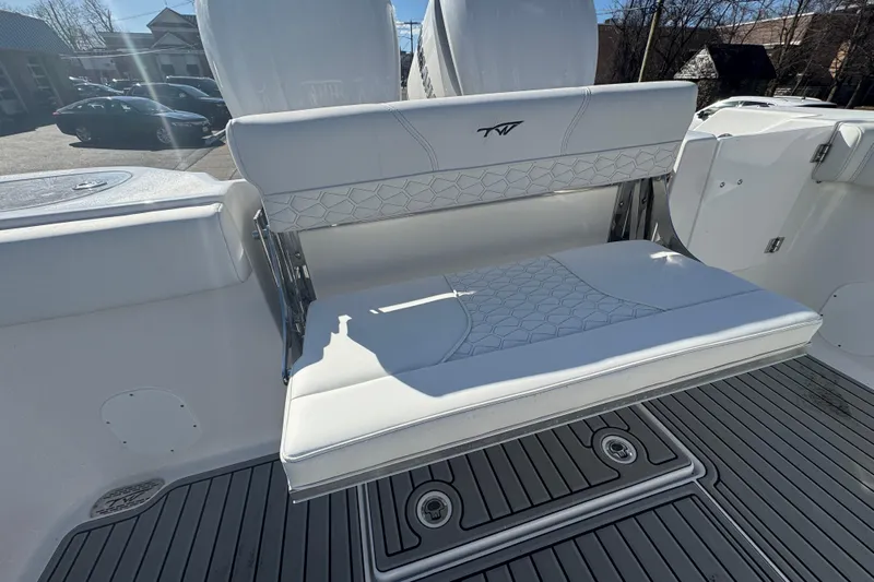  Yacht Photos Pics 2026 Tidewater 320 CC Adventure boat with white cushioned seating and sleek design.