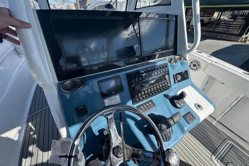 Yacht Photos Pics Helm of 2026 Tidewater 320 CC Adventure boat with advanced controls and displays.