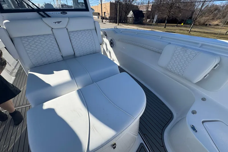 Yacht Photos Pics 2026 Tidewater 320 CC Adventure boat interior with white cushioned seating and sleek design.