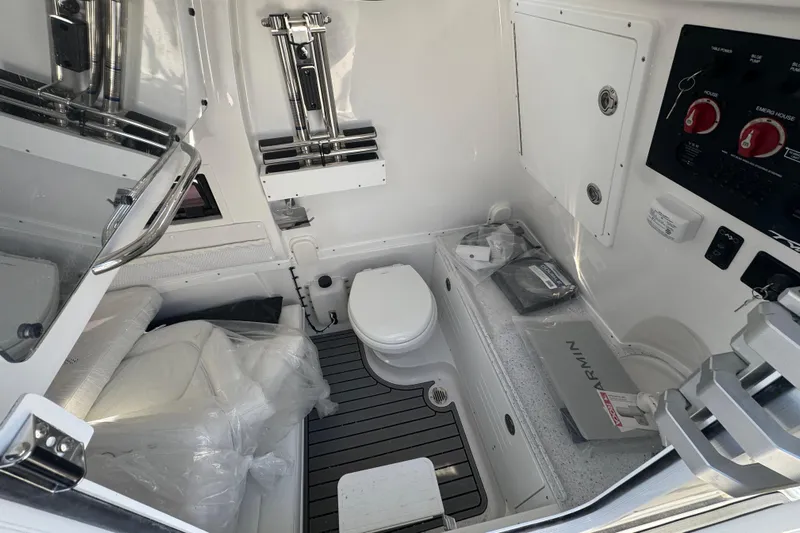  Yacht Photos Pics 2026 Tidewater 320 CC Adventure boat interior with toilet and control panel.