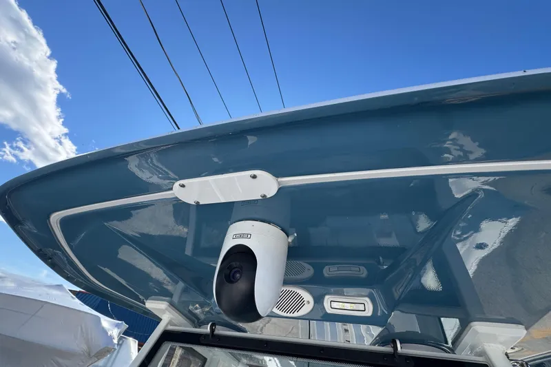  Yacht Photos Pics 2026 Tidewater 320 CC Adventure boat with mounted camera under blue sky.