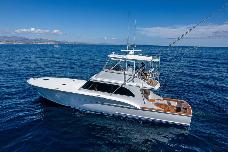 Will Rise Yacht Photos Pics Custom Carolina 58 yacht, 2005 model, cruising on clear blue ocean waters.