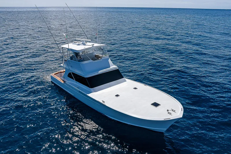 Will Rise Yacht Photos Pics Custom Carolina 58 yacht, 2005 model, cruising on open blue ocean.