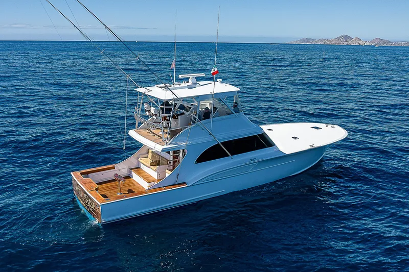 Will Rise Yacht Photos Pics Custom Carolina 58 yacht, 2005 model, cruising on open blue sea.