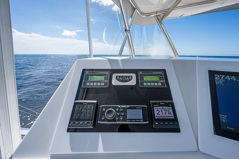Will Rise Yacht Photos Pics Control panel of a 2005 Custom Carolina 58 boat with ocean view.