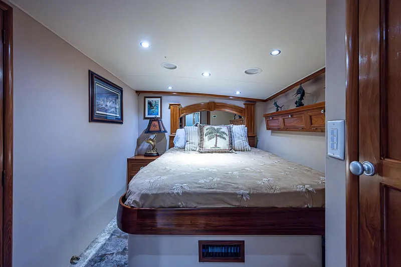 Will Rise Yacht Photos Pics Luxurious bedroom interior of 2005 Custom Carolina 58 yacht with cozy bed and elegant decor.