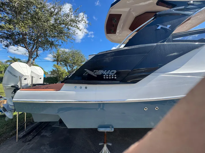  Yacht Photos Pics 2025 NX Boats NX340 Sport Coupe with Mercury engines, docked outdoors.