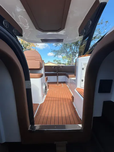  Yacht Photos Pics Interior view of 2025 NX Boats NX340, featuring sleek wood flooring and modern seating.