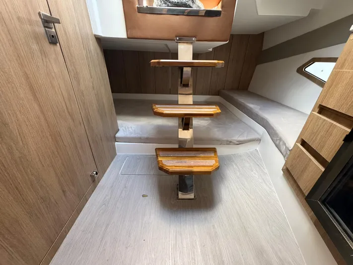  Yacht Photos Pics Interior of 2025 NX Boats NX340, featuring wooden steps and modern cabin design.