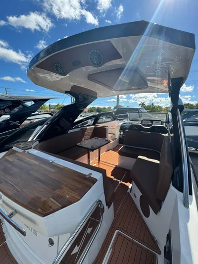  Yacht Photos Pics 2025 NX Boats NX340 interior with seating, table, and canopy under a sunny sky.