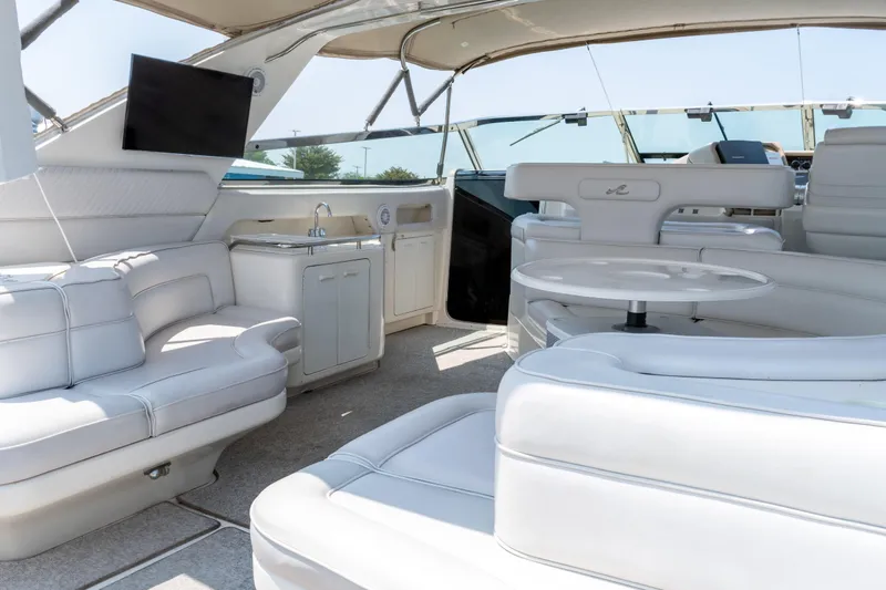  Yacht Photos Pics Luxurious interior of 1996 Sea Ray 630 Super Sun Sport yacht with white seating and amenities.