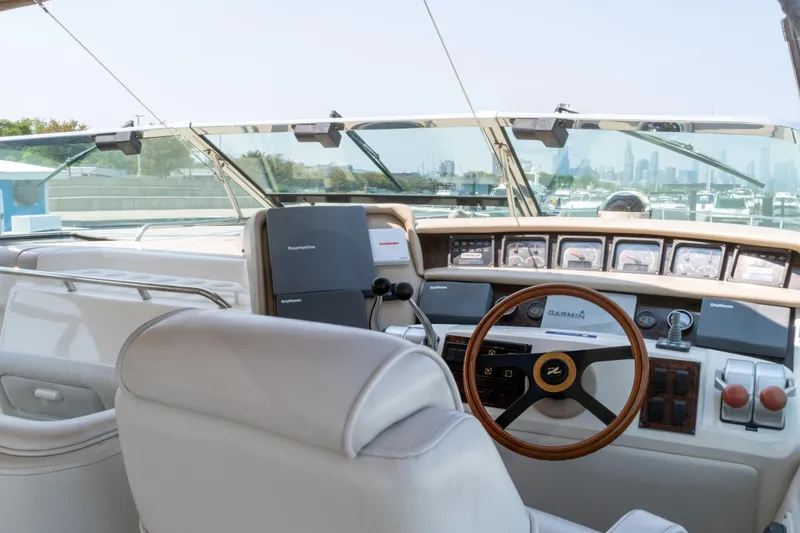  Yacht Photos Pics Interior view of 1996 Sea Ray 630 Super Sun Sport yacht cockpit with steering wheel and controls.