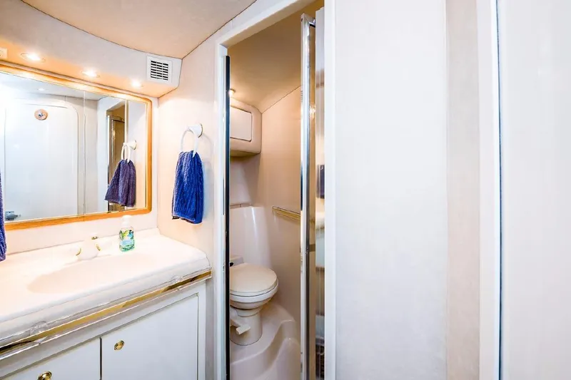  Yacht Photos Pics Luxurious bathroom in 1996 Sea Ray 630 Super Sun Sport yacht, featuring elegant fixtures and lighting.