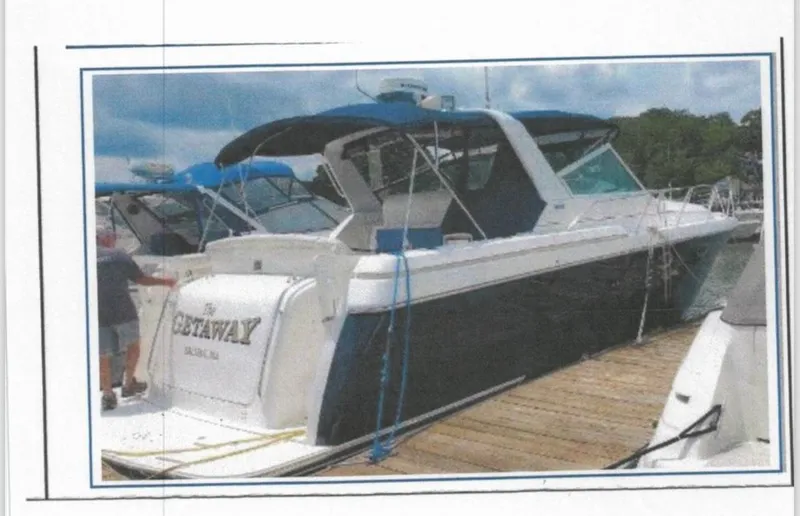 Getaway Yacht Photos Pics 2001 Tiara Yachts 3500 Express docked, featuring sleek design and blue canopy.