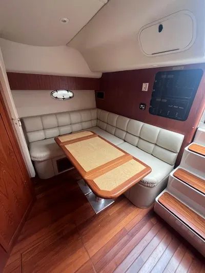 Getaway Yacht Photos Pics 2001 Tiara Yachts 3500 Express interior with wood flooring and cushioned seating.