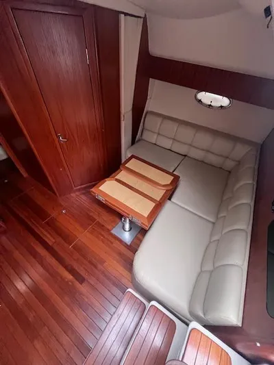 Getaway Yacht Photos Pics 2001 Tiara Yachts 3500 Express interior with wood flooring and leather seating.