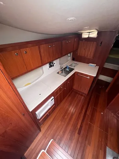 Getaway Yacht Photos Pics 2001 Tiara Yachts 3500 Express interior with wood cabinetry and flooring.