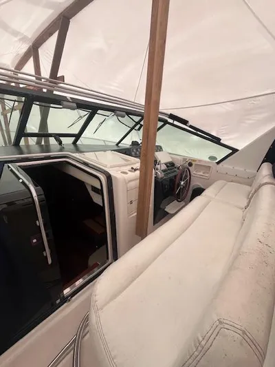 Getaway Yacht Photos Pics 2001 Tiara Yachts 3500 Express interior with helm and seating under cover.