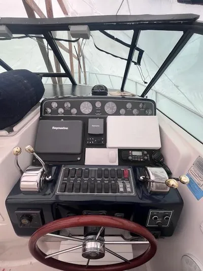 Getaway Yacht Photos Pics 2001 Tiara Yachts 3500 Express helm with navigation controls and steering wheel.