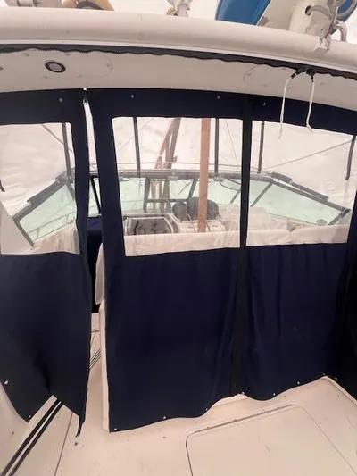 Getaway Yacht Photos Pics 2001 Tiara Yachts 3500 Express with navy blue cockpit enclosure.