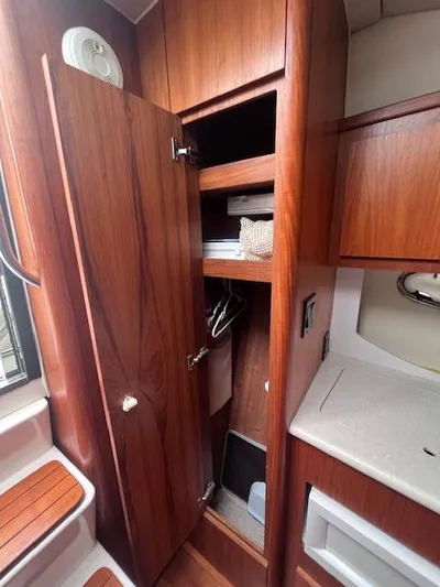 Getaway Yacht Photos Pics 2001 Tiara Yachts 3500 Express interior with wooden cabinetry and storage.