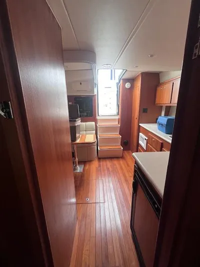 Getaway Yacht Photos Pics Interior of 2001 Tiara Yachts 3500 Express with wooden flooring and modern kitchen amenities.
