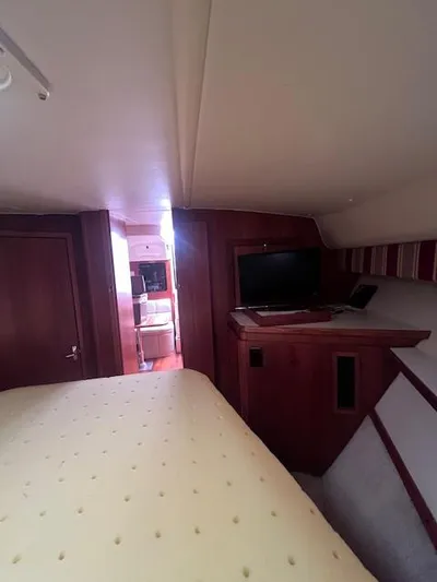 Getaway Yacht Photos Pics Interior of 2001 Tiara Yachts 3500 Express, featuring cozy cabin with TV and bed.