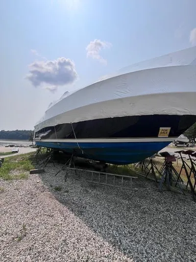 Getaway Yacht Photos Pics 2001 Tiara Yachts 3500 Express boat on land, covered, with clear sky background.