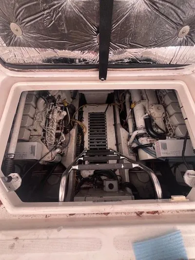 Getaway Yacht Photos Pics Engine compartment of 2001 Tiara Yachts 3500 Express, showcasing dual engines and mechanical components.