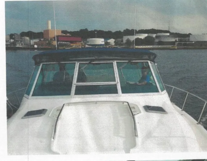 Getaway Yacht Photos Pics 2001 Tiara Yachts 3500 Express cruising near industrial waterfront.