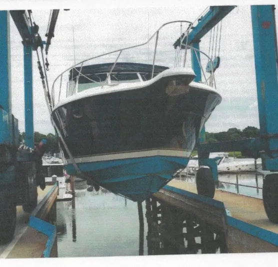 Getaway Yacht Photos Pics 2001 Tiara Yachts 3500 Express being lifted at a marina.