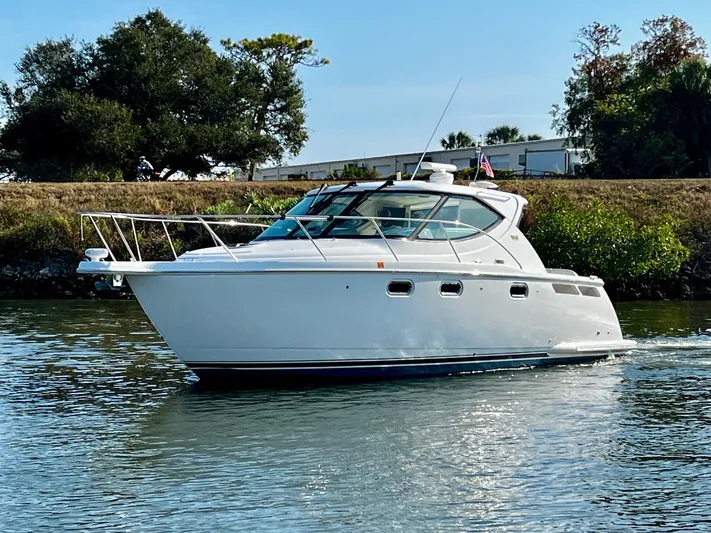 " Toes In The Sand " Yacht Photos Pics 2011 Tiara Yachts Sovran on calm water, side view.