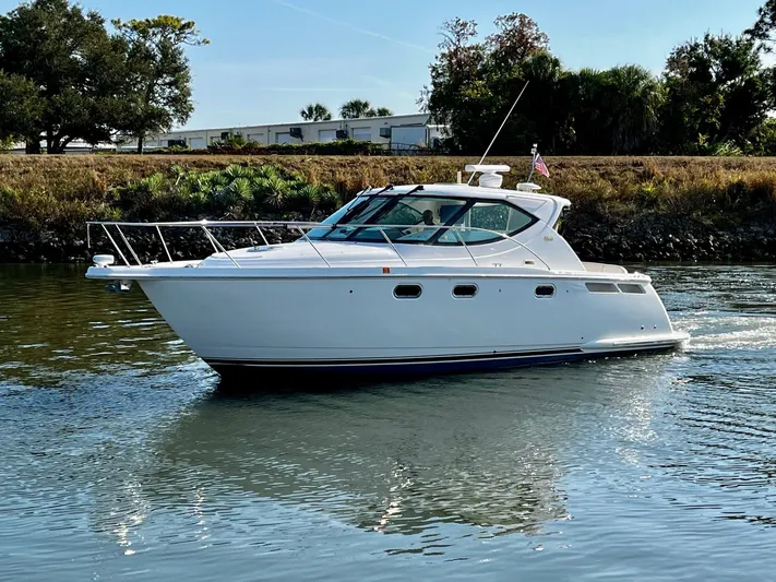 " Toes In The Sand " Yacht Photos Pics 2011 Tiara Yachts Sovran cruising on calm water.