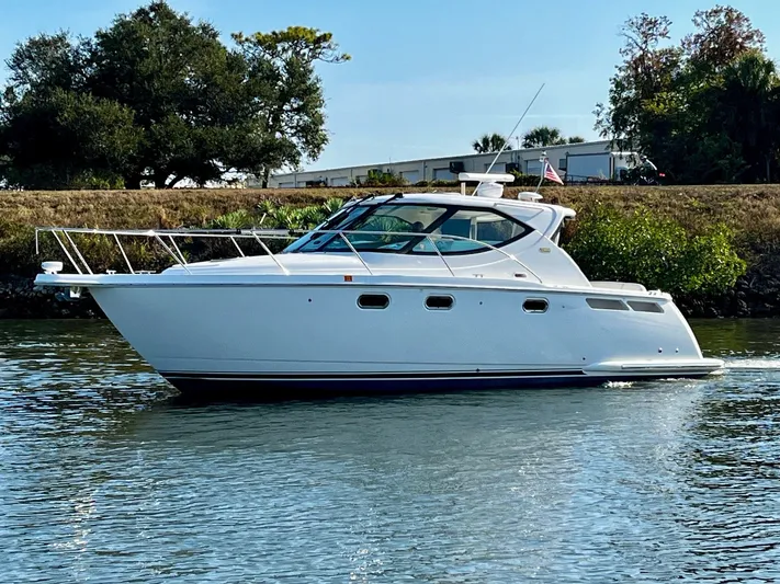 " Toes In The Sand " Yacht Photos Pics 2011 Tiara Yachts Sovran on calm water, side view.