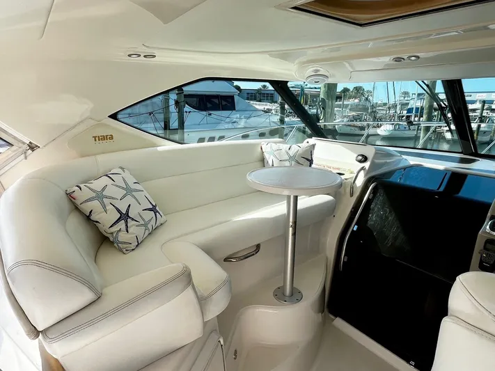 " Toes In The Sand " Yacht Photos Pics Interior of 2011 Tiara Yachts Sovran with white seating and table.