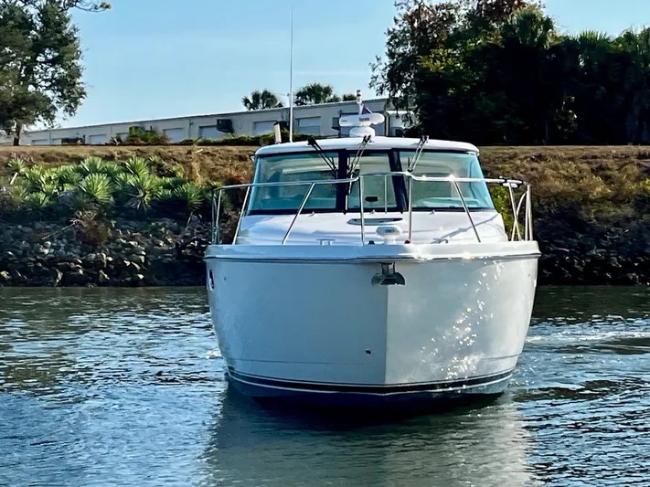 " Toes In The Sand " Yacht Photos Pics 2011 Tiara Yachts Sovran on calm water, front view.