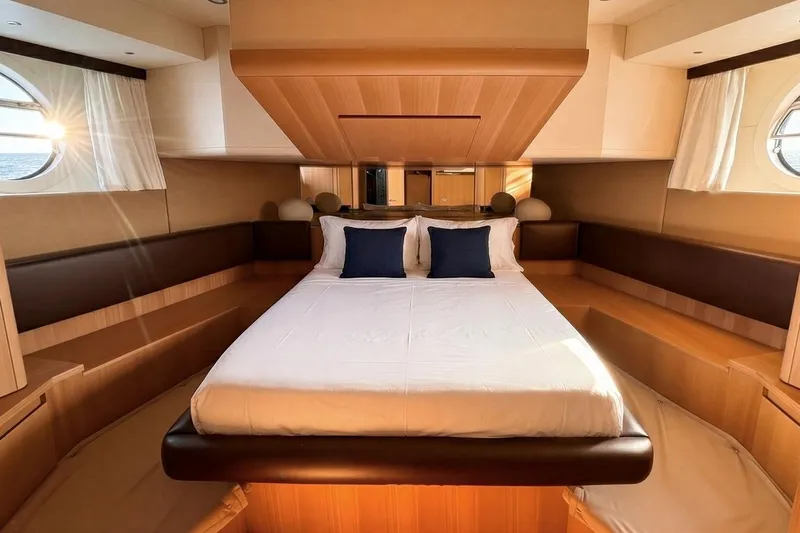  Yacht Photos Pics Luxurious bedroom interior of 2015 Aicon 85 yacht with elegant wood finish and plush bedding.