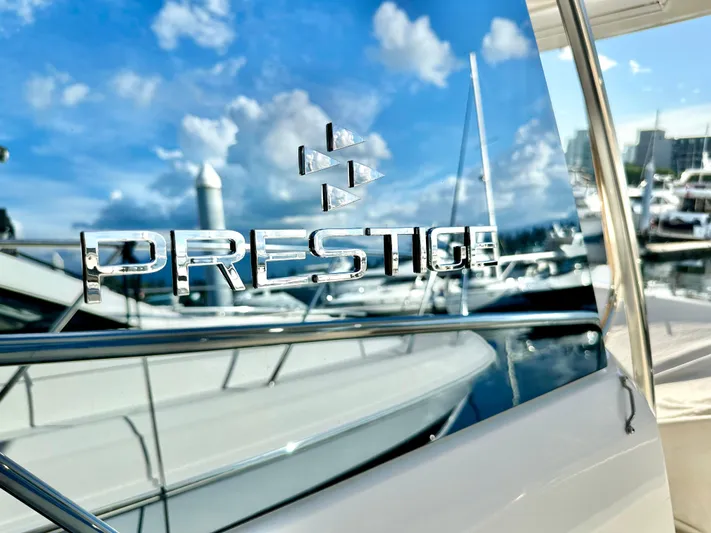 Pearl Voyage Yacht Photos Pics 2023 Prestige 520 yacht with reflective logo at marina.