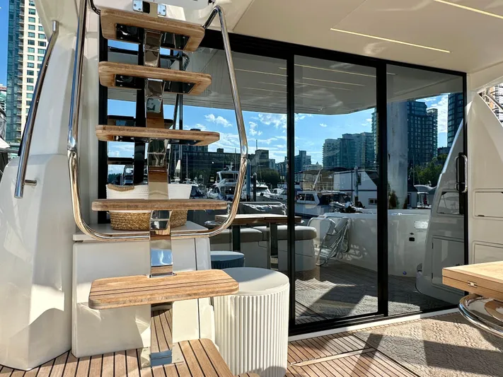 Pearl Voyage Yacht Photos Pics Luxury yacht Prestige 520, 2023 model, featuring elegant wooden stairs and modern glass doors.