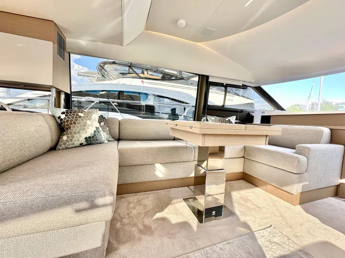 Pearl Voyage Yacht Photos Pics Luxurious interior of 2023 Prestige 520 yacht with modern seating and elegant decor.