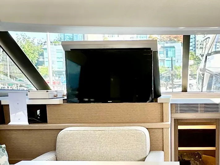 Pearl Voyage Yacht Photos Pics Interior of 2023 Prestige 520 yacht with modern TV and seating area.