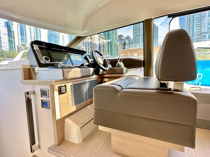 Pearl Voyage Yacht Photos Pics Interior of 2023 Prestige 520 yacht with modern helm and cityscape view.