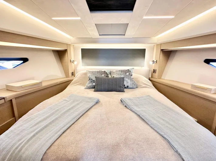 Pearl Voyage Yacht Photos Pics Luxurious bedroom interior of 2023 Prestige 520 yacht with elegant bedding and modern lighting.