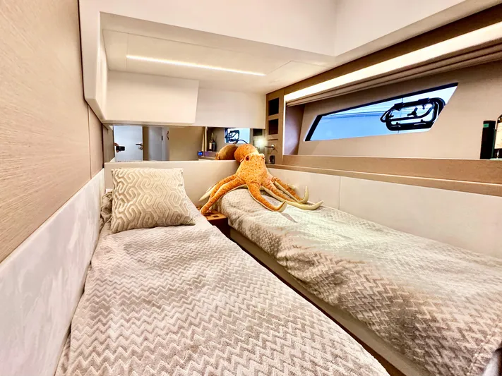 Pearl Voyage Yacht Photos Pics Luxurious 2023 Prestige 520 yacht cabin with twin beds and plush decor.