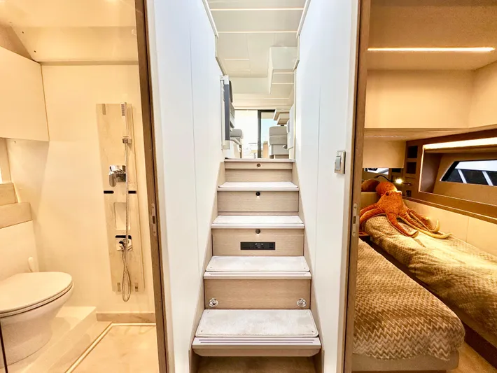 Pearl Voyage Yacht Photos Pics Interior of 2023 Prestige 520 yacht with stairs, bathroom, and cozy bedroom.